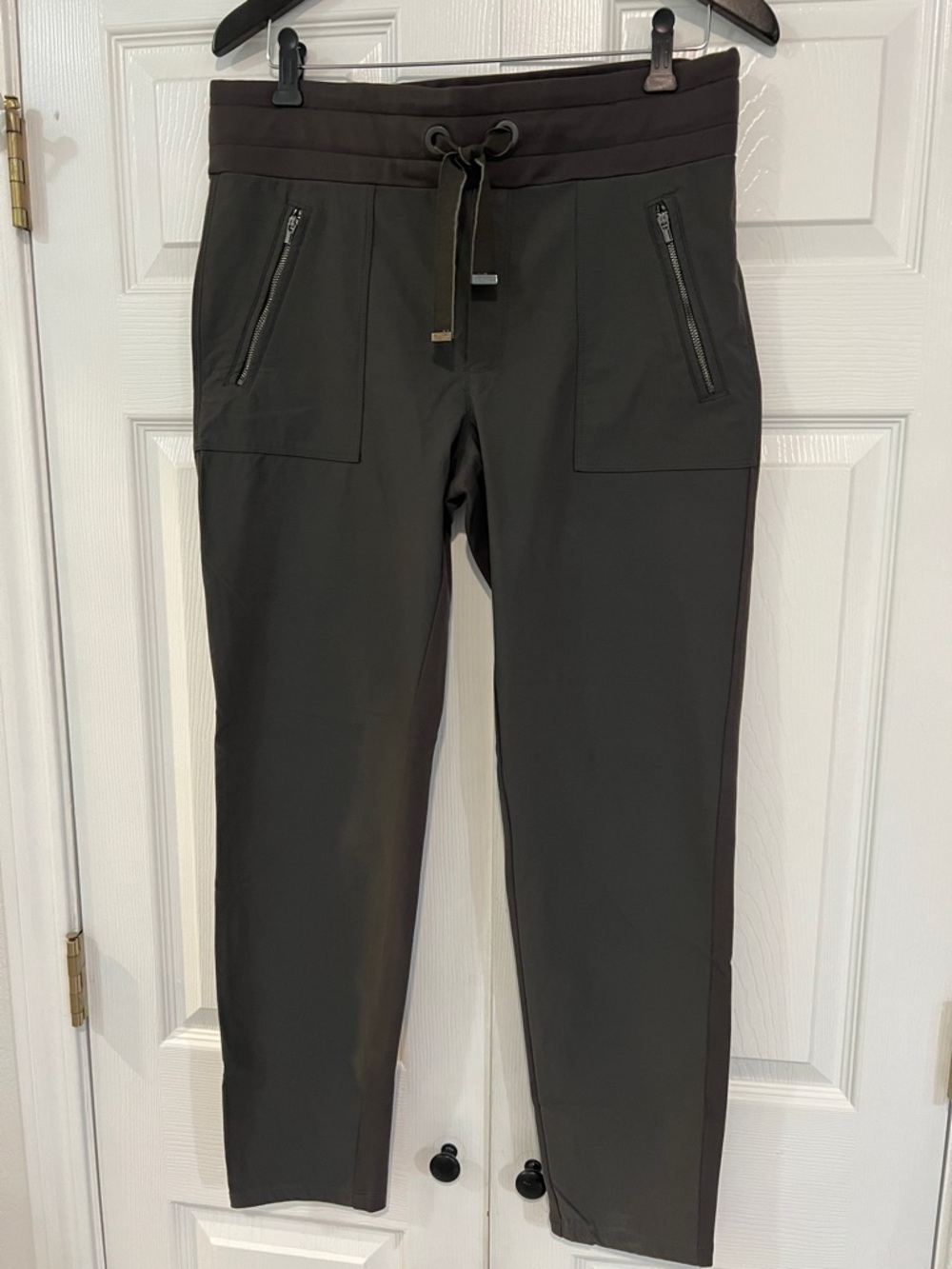 Athleta stretch pants, leggings. Size 12. zip pockets. Dark olive green